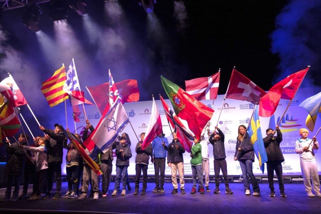 Young sailors holding their flags at the Euromarina Optimist Trophy Torrevieja Welcome Party.